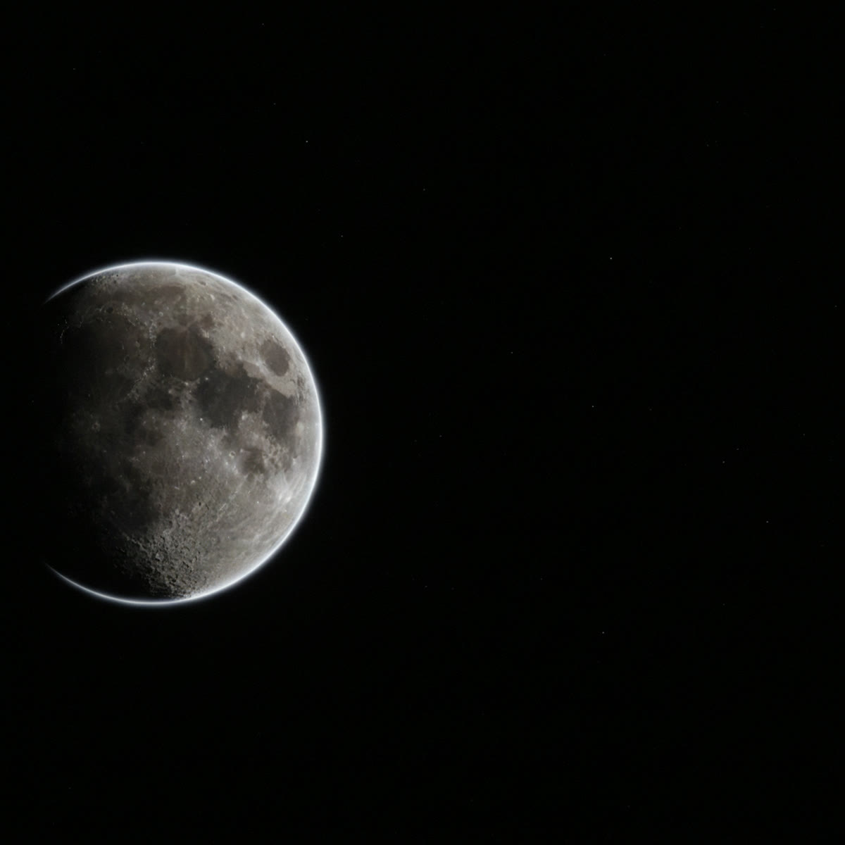 A close, rim-lit moon against black — the moon at perigee.